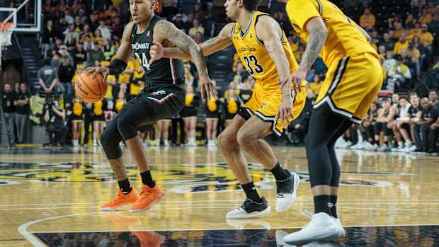 Jan 5, 2023; Wichita, Kansas, USA; Cincinnati Bearcats guard Jeremiah Davenport (24) works around Wichita State Shockers forward James Rojas (33) during the second half at Charles Koch Arena. Mandatory Credit: William Purnell-USA TODAY Sports